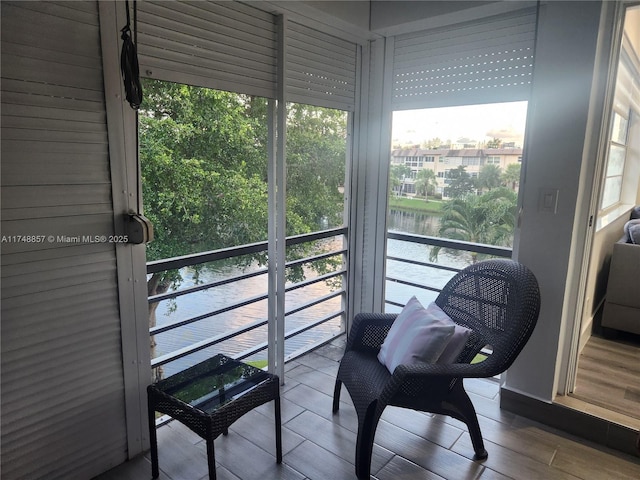 sunroom / solarium with a water view