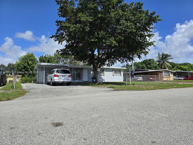 view of front of property featuring driveway and a carport