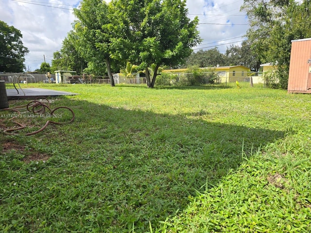 view of yard featuring fence and central air condition unit