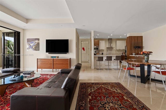 living area with a tray ceiling and recessed lighting