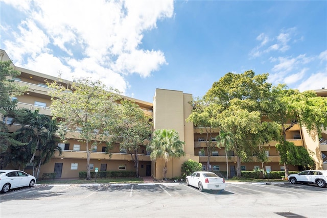 view of property featuring uncovered parking