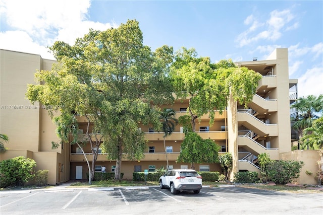 view of property featuring uncovered parking