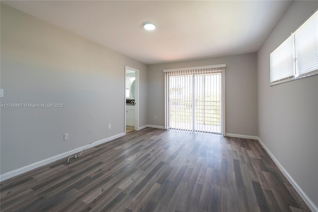 unfurnished room with dark wood-style flooring and baseboards