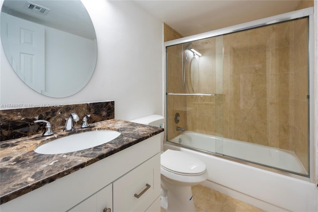 full bath with shower / bath combination with glass door, visible vents, toilet, vanity, and tile patterned flooring