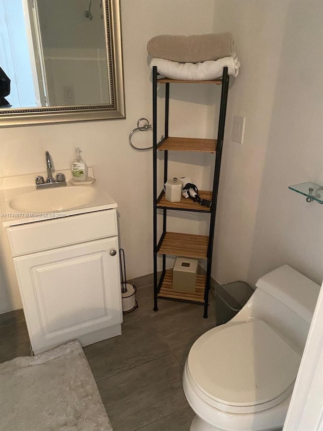 bathroom featuring vanity, toilet, and wood finished floors