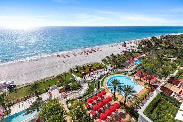 bird's eye view featuring a water view and a view of the beach