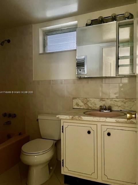 bathroom with toilet, tile patterned flooring, shower / washtub combination, and vanity