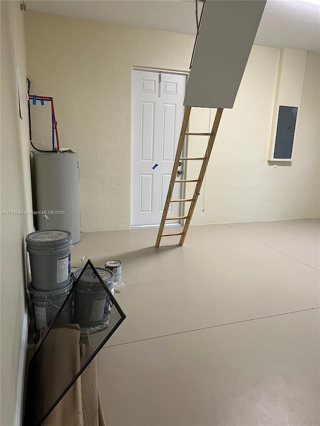 basement featuring electric panel, water heater, and a textured wall