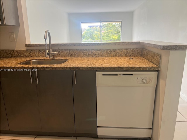 kitchen featuring dishwasher, modern cabinets, and a sink