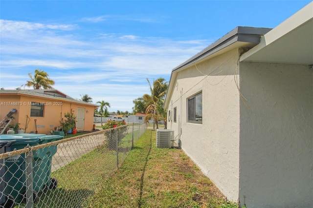 view of yard featuring cooling unit and fence