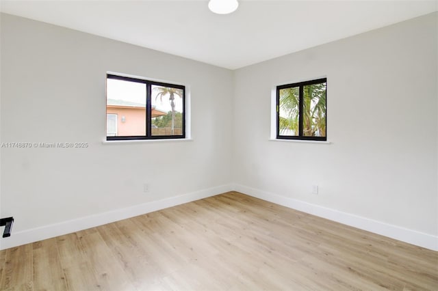 empty room featuring light wood-style floors and baseboards