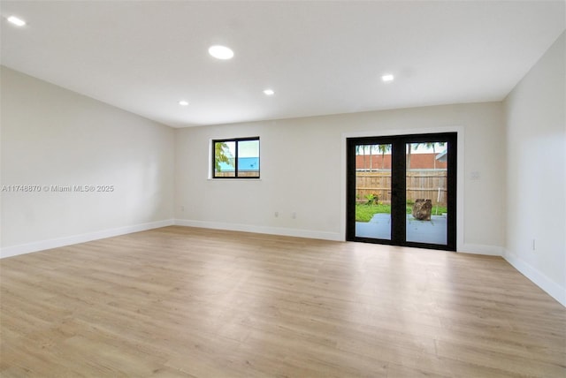 spare room with light wood-style flooring, baseboards, and recessed lighting