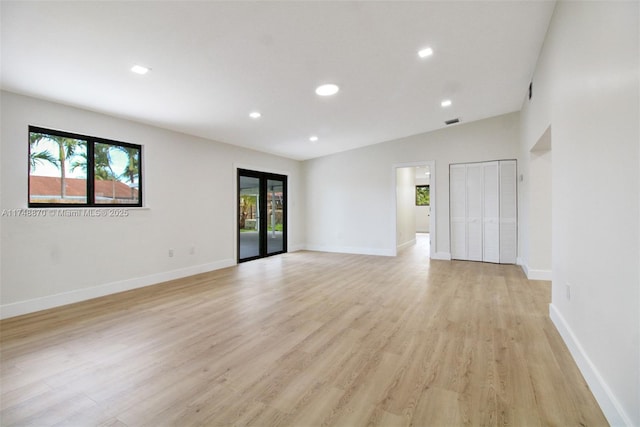 spare room featuring light wood-style flooring, visible vents, baseboards, and recessed lighting