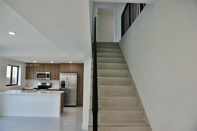 stairway featuring tile patterned flooring and recessed lighting