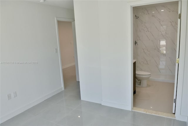 bathroom featuring a marble finish shower, baseboards, toilet, and tile patterned floors