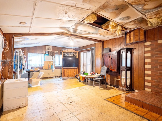 interior space with light floors, wooden walls, and a wealth of natural light