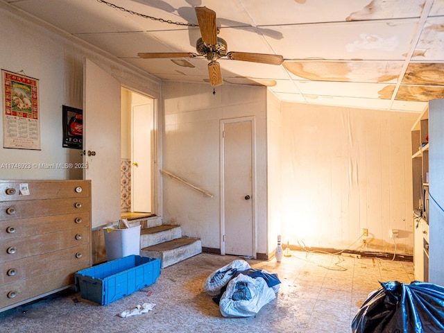 interior space with a ceiling fan and stairway