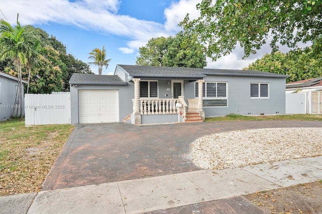 ranch-style home featuring aphalt driveway, a porch, a garage, fence, and crawl space