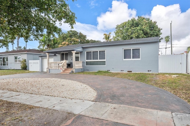 single story home with a garage, driveway, and fence