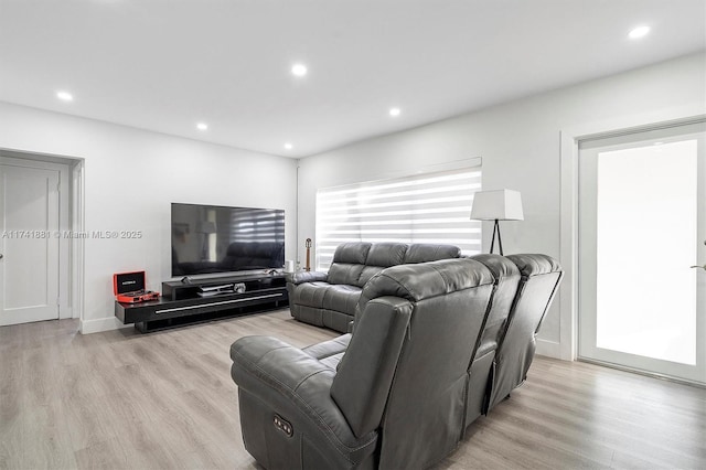 living area featuring light wood finished floors and recessed lighting