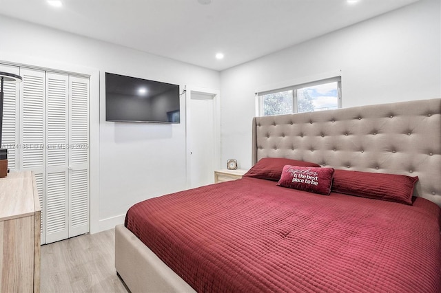 bedroom with recessed lighting, a closet, and light wood-style flooring