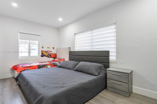 bedroom featuring light wood-style flooring and baseboards