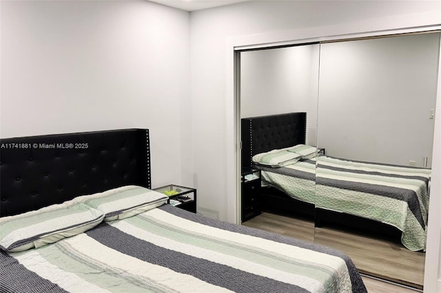 bedroom featuring a closet and wood finished floors