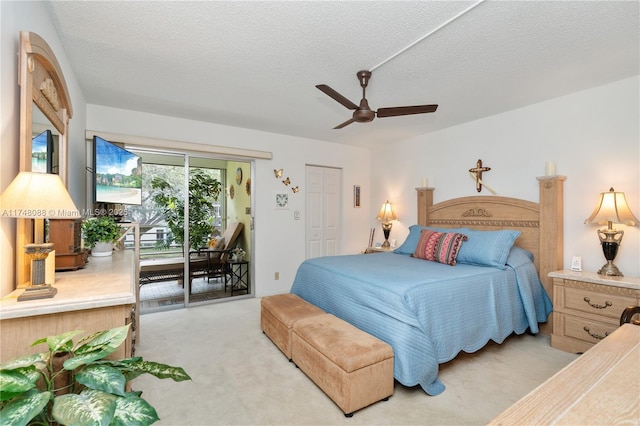 bedroom with access to outside, light carpet, ceiling fan, and a textured ceiling