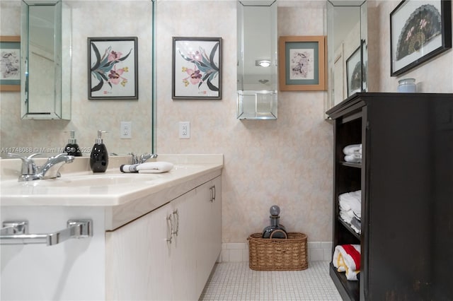 bathroom with baseboards, tile patterned flooring, vanity, and wallpapered walls