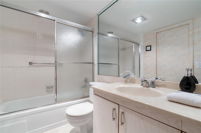 full bathroom with toilet, shower / bath combination with glass door, and vanity