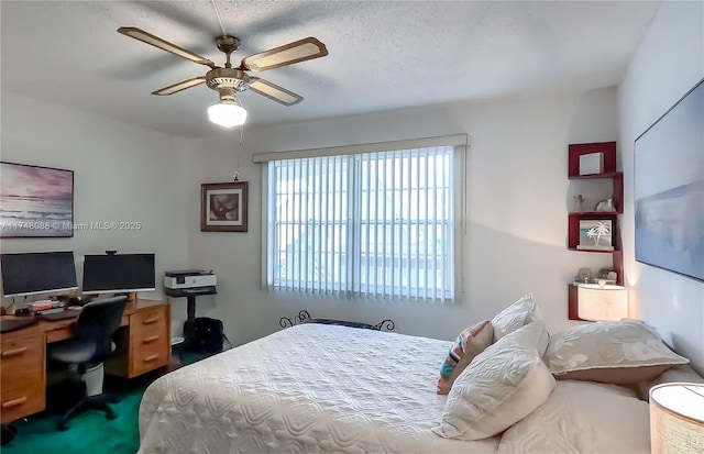 carpeted bedroom featuring a ceiling fan and a textured ceiling