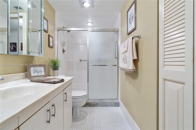 full bathroom featuring toilet, vanity, baseboards, a shower stall, and tile patterned floors