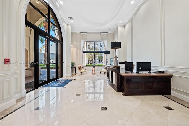 home office with french doors, marble finish floor, crown molding, visible vents, and a decorative wall