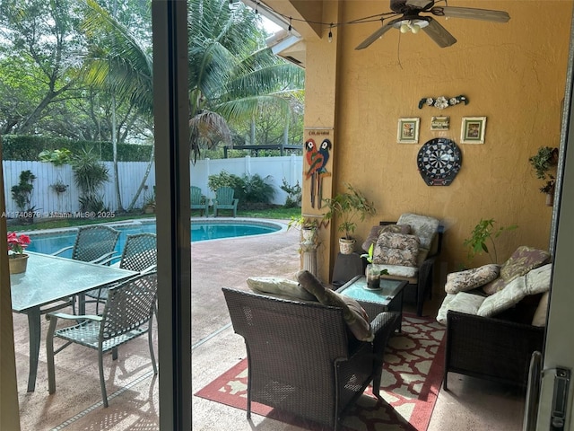 exterior space with a fenced in pool, a fenced backyard, a patio, and ceiling fan