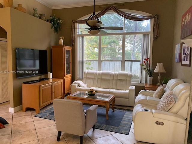 living area featuring ornamental molding, light tile patterned flooring, and a ceiling fan