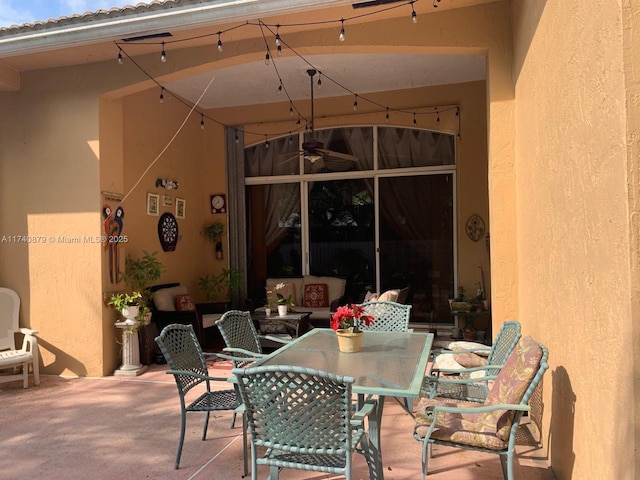 view of patio / terrace with outdoor dining space and a ceiling fan