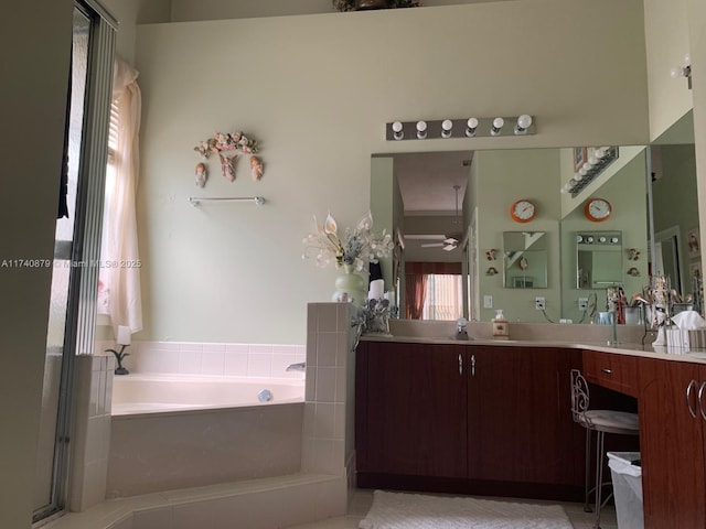 full bath with double vanity, a sink, and a bath