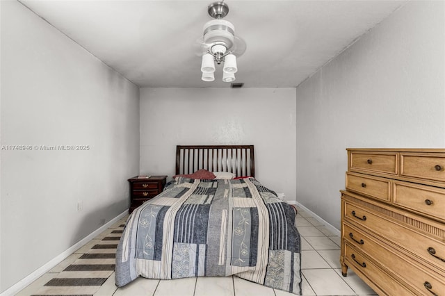 bedroom with light tile patterned floors and baseboards