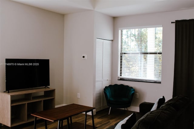 living area with a wealth of natural light and dark wood-style flooring