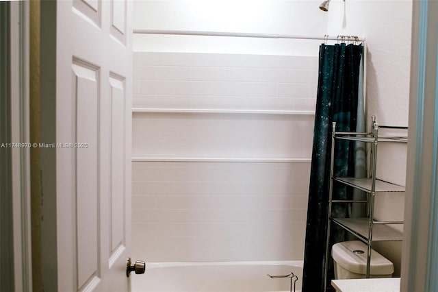 bathroom featuring shower / bath combo and toilet