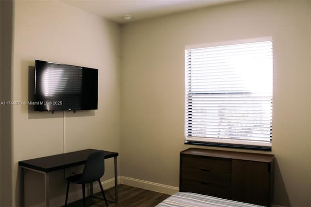 office area with dark wood-style floors and baseboards