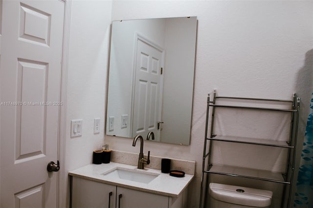 bathroom featuring toilet and vanity