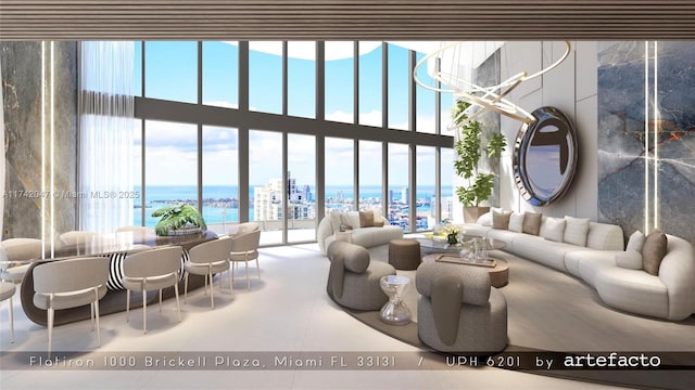 living area with a high ceiling, floor to ceiling windows, a healthy amount of sunlight, and a water view