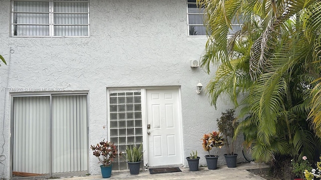 doorway to property with stucco siding