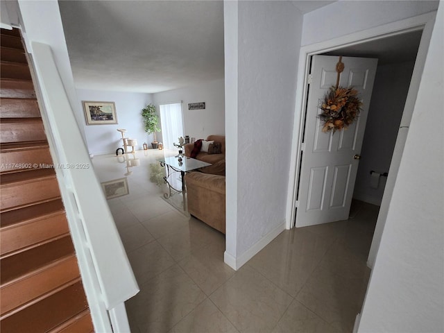 8485 SW 156th Pl Unit 106, Miami, FL 33193 - hallway with stairway, tile patterned flooring, and baseboards