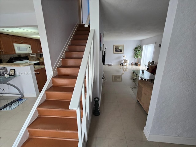 stairs featuring tile patterned floors