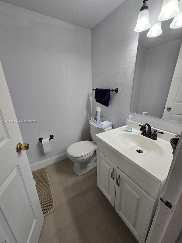 bathroom with toilet and vanity