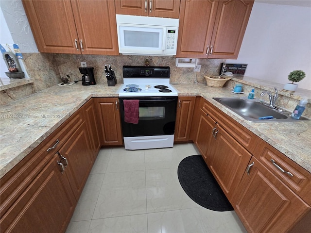 kitchen with electric range, white microwave, a sink, light countertops, and tasteful backsplash
