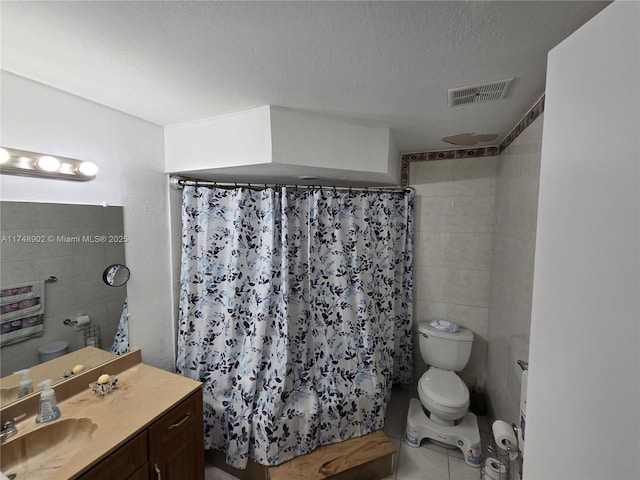 full bath with visible vents, tile patterned flooring, vanity, toilet, and a textured ceiling