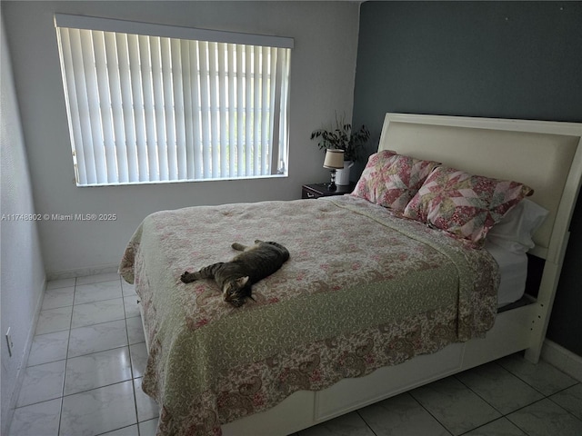 bedroom featuring baseboards and marble finish floor